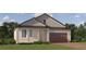 One-story home with a brown door and brick driveway at 9650 Minnow Ray Dr, Land O Lakes, FL 34638