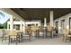 Covered patio bar with seating and multiple fans at 9650 Minnow Ray Dr, Land O Lakes, FL 34638