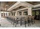 Long outdoor bar with many wicker chairs at 9650 Minnow Ray Dr, Land O Lakes, FL 34638