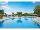 Resort-style pool with lounge chairs and cabanas at 9650 Minnow Ray Dr, Land O Lakes, FL 34638