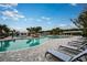 Relaxing pool area with lounge chairs and lush landscaping at 9650 Minnow Ray Dr, Land O Lakes, FL 34638
