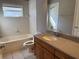 Bathroom with tub, toilet and vanity with wood cabinets at 11321 Flora Springs Dr, Riverview, FL 33579