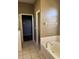 Bathroom with garden tub and access to a walk-in closet at 11321 Flora Springs Dr, Riverview, FL 33579