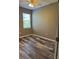 Bright bedroom with wood-look floors and window blinds at 11321 Flora Springs Dr, Riverview, FL 33579