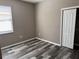 Spacious bedroom featuring wood-look floors and a closet at 11321 Flora Springs Dr, Riverview, FL 33579