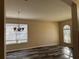 Spacious dining room featuring wood-look floors and a chandelier at 11321 Flora Springs Dr, Riverview, FL 33579
