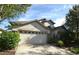 Two-story house with beige walls, stone accents, and a two-car garage at 11321 Flora Springs Dr, Riverview, FL 33579