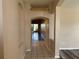 Long hallway with tile floors connecting to the living areas at 11321 Flora Springs Dr, Riverview, FL 33579