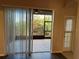 Living room with sliding glass doors leading to a screened patio at 11321 Flora Springs Dr, Riverview, FL 33579