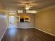 Spacious living room with wood-look floors and a ceiling fan at 11321 Flora Springs Dr, Riverview, FL 33579