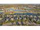 Aerial view of a large community by a golf course and lake at 1141 Jameson Greens Dr # 3, Sun City Center, FL 33573