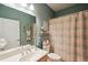 Well-appointed bathroom with shower, sink, and striped curtains at 1141 Jameson Greens Dr # 3, Sun City Center, FL 33573