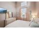 Bright bedroom with a queen bed, large mirror, and window at 1141 Jameson Greens Dr # 3, Sun City Center, FL 33573