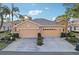 Front view of a tan house with a double garage at 1141 Jameson Greens Dr # 3, Sun City Center, FL 33573