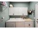 Laundry room with washer, dryer, cabinets, and shelving at 1141 Jameson Greens Dr # 3, Sun City Center, FL 33573