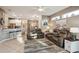 Open living room with kitchen view and gray couches at 1141 Jameson Greens Dr # 3, Sun City Center, FL 33573