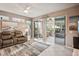 Bright living room with leather seating and sliding doors leading to a relaxing sunroom at 1141 Jameson Greens Dr # 3, Sun City Center, FL 33573