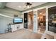 Sunroom features a TV, comfortable seating, and sliding doors leading to the outdoors at 1141 Jameson Greens Dr # 3, Sun City Center, FL 33573