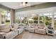 Sunroom boasts ample natural light, comfortable seating, and relaxing water views at 1141 Jameson Greens Dr # 3, Sun City Center, FL 33573
