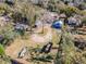 Aerial view showing property with surrounding buildings and trees at 14035 21St St, Dade City, FL 33525