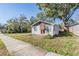 Cute one-story house with a sidewalk and mature trees at 14035 21St St, Dade City, FL 33525