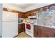 Kitchen features wood cabinets and white appliances at 14035 21St St, Dade City, FL 33525