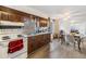 Kitchen with wood cabinets, white appliances, and laminate floors at 14035 21St St, Dade City, FL 33525