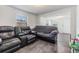 Living room with gray sofa and dark tile floors at 14035 21St St, Dade City, FL 33525