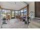 Screened porch with table, chairs, and exercise equipment at 14035 21St St, Dade City, FL 33525