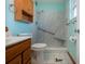 Accessible bathroom featuring a walk-in shower and built-in seat at 1518 Chevy Chase Dr, Sun City Center, FL 33573