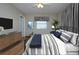 Main bedroom with a bed, dresser, and large TV at 1518 Chevy Chase Dr, Sun City Center, FL 33573