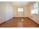 Spacious bedroom featuring laminate wood flooring and large windows at 1518 Chevy Chase Dr, Sun City Center, FL 33573