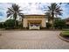 Elegant entrance to Club Renaissance with palm trees and a paved circular driveway at 1518 Chevy Chase Dr, Sun City Center, FL 33573