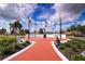 Brick pathway leads to a community monument with flags and patriotic sculptures at 1518 Chevy Chase Dr, Sun City Center, FL 33573