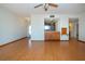 Open dining area with wood floors and kitchen view at 1518 Chevy Chase Dr, Sun City Center, FL 33573