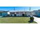 Ranch-style home with carport and landscaped lawn at 1518 Chevy Chase Dr, Sun City Center, FL 33573