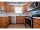 Modern kitchen featuring stainless steel appliances and wood cabinetry at 1518 Chevy Chase Dr, Sun City Center, FL 33573