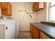 Convenient laundry room with washer, dryer, and ample cabinetry at 1518 Chevy Chase Dr, Sun City Center, FL 33573