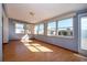 Bright sunroom with multiple windows and laminate flooring at 1518 Chevy Chase Dr, Sun City Center, FL 33573