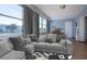 Sunroom with gray sectional sofa and large windows at 1518 Chevy Chase Dr, Sun City Center, FL 33573