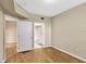 Well-lit bedroom with wood-look floors and access to bathroom and hallway at 1810 E Palm Ave # 5113, Tampa, FL 33605