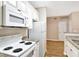 White kitchen with granite counters and appliances at 1810 E Palm Ave # 5113, Tampa, FL 33605