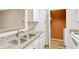 Kitchen with granite counters, double sink, and laundry at 1810 E Palm Ave # 5113, Tampa, FL 33605