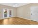 Bright living room with wood-look floors, sliding doors to balcony, and neutral walls at 1810 E Palm Ave # 5113, Tampa, FL 33605