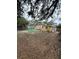 Spacious backyard with mature trees and a playset at 2916 W Ellis Dr, Tampa, FL 33611