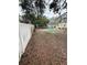 Large backyard with a play area and white vinyl fence at 2916 W Ellis Dr, Tampa, FL 33611