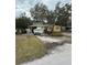 Yellow ranch home with a boat on a trailer in the driveway at 2916 W Ellis Dr, Tampa, FL 33611