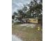 Yellow ranch home with a large yard and fire hydrant at 2916 W Ellis Dr, Tampa, FL 33611