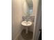 Small bathroom with pedestal sink and grey tile at 3005 Suncoast Blend Dr, Odessa, FL 33556