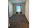 Spacious bedroom with grey carpeting and a large window at 3005 Suncoast Blend Dr, Odessa, FL 33556
